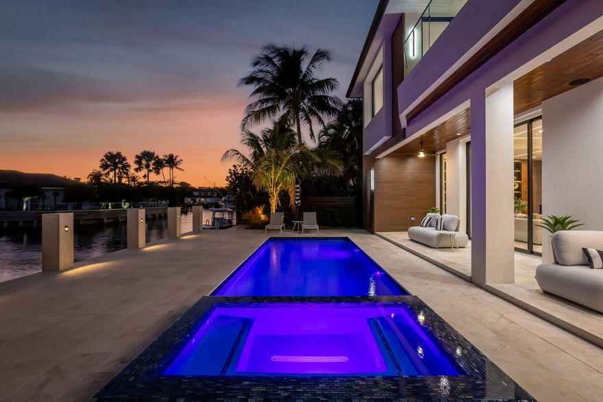 Completed in 2025, this modern waterfront residence offers 84' of deep water frontage, direct ocean access with no fixed bridges, and a private dock with a 20,000 lb boat lift. A marble driveway and refined entry lead to interiors defined by floor to ceiling glass, natural stone, and warm finishes. The great room opens to a resort style waterfront terrace with saltwater pool, integrated spa, outdoor shower, and cabana bath. The chef's kitchen features bespoke European cabinetry, Wolf and Sub-Zero appliances, dual dishwashers, dual zone wine storage, and a hidden walk in pantry. The primary offers spa level luxury with steam shower, sauna, soaking tub, and custom closets. Additional features include whole home automation, security cameras, whole home generator, and a three car garage.