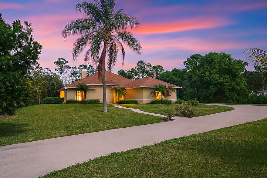 A Rare Acreage Retreat with Room to Breathe and Space to Live the Florida Lifestyle set on a full 2 acres, this 4-bedroom, 3-bath CBS pool home offers the perfect blend of space, comfort, and Florida lifestyle freedom. Inside, a two-sided coral fireplace, vaulted ceilings, and all-tile or wood floors set the tone for stylish country living. The huge kitchen with prep island and stainless appliances and quartz counter tops opens to a bright family room with sliders leading to a screened pool and large covered patio area that is a great entertaining space --your own backyard oasis surrounded by lush tropical landscaping. Enjoy total privacy yet stay minutes from shopping, schools, and Wellington amenities. A fenced dog yard, circular driveway, and 2-car garage make everyday living easy.