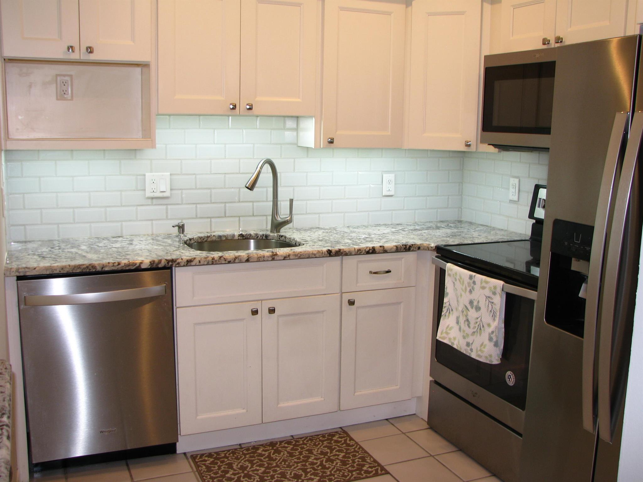 MUST SEE - MANY UPGRADES. FIRST FLOOR Newly painted unit in Poppleton Creek. Beautiful kitchen with stainless steel appliances (2020). Soft close kitchen cabinets & drawers with under cabinet lighting. Split bedrooms each with own bathroom & impact windows. Comfort height toilet in main bath. Impact sliding door (with accordion shutters) leading to outdoor private patio surrounded by lush landscaping. Newer a/c (2025), water heater (2024), and updated electrical panel (2024). Blue Stream basic cable & internet. New roof installed in 2024. Within walking distance to downtown Stuart, restaurants & Publix shopping center. Close to Intercoastal waterways and beach. Poppleton Creek has 2 swimming pools & clubhouses. Community laundry room & storage closet located steps away from unit.