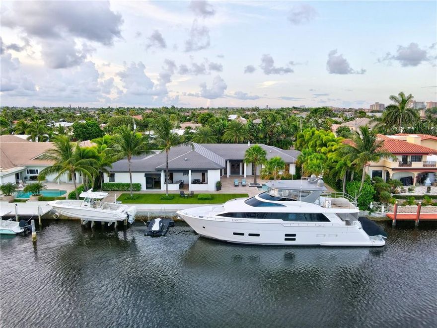 Newly Priced! A Yachtsman's dream! Gorgeous Deepwater estate facing south, along the North Grand Canal in Lighthouse Point. Enjoy 135 feet of waterfront w/ mega yacht dockage, a 15K boat lift, huge turning basin & plenty of depth; perfect for a large vessel. This sprawling single level 4 bed/ 4 bath sits on 1.5 lots, is timeless in design, features lush manicured landscaping, boasts an expansive resort-style pool overlooking the LHP Yacht Club. The outdoor lanai w/ bar, BBQ & fireplace coupled w/ the dockside firepit provide for luxe entertaining space. This protected sanctuary off the ICWW is just minutes from the Hillsboro Inlet. Gourmet chef's kitchen, comfortably chic living spaces, luxurious master suite & water views from every room create the perfect waterfront living experience! A Yachtsman's dream! Join us for an Open House Sunday, January 30 from 12:00- 3:00. Gorgeous Deepwater estate facing south, along the North Grand Canal in Lighthouse Point. Enjoy 135 feet of waterfront with mega yacht dockage, a 15K boat lift, huge turning basin & plenty of depth; perfect for a large vessel.