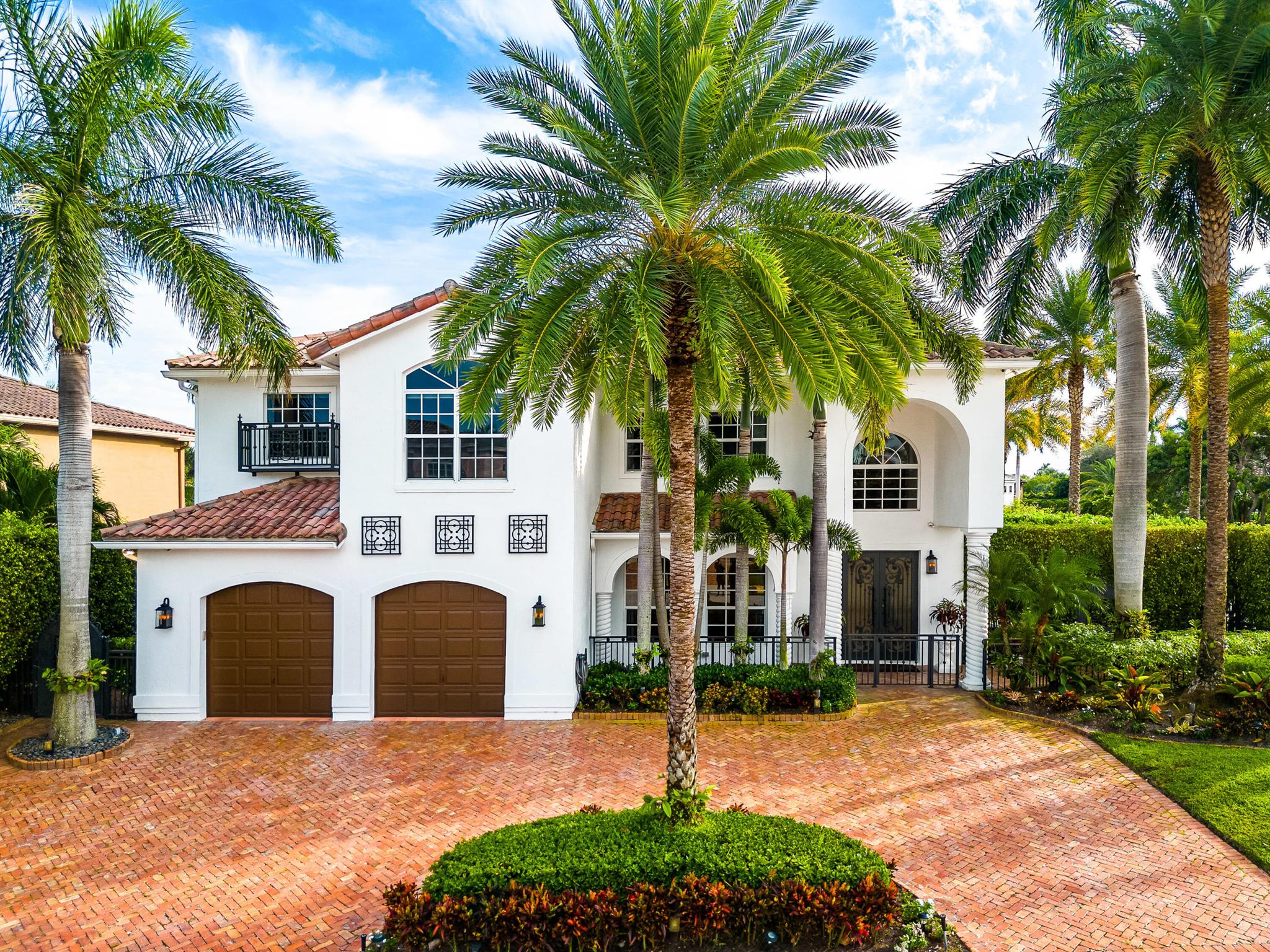 Welcome to your dream home, a haven of tranquility nestled within the heart of Boca Raton in Boca East Estates. This stunning residence, perfectly situated on a beautifully landscaped lot, exudes timeless elegance and true curb appeal.As you step through the grand entrance into the foyer, your senses will be immediately captivated by the high ceilings and the elegant interior. The home effortlessly guides you towards one of the inviting sitting rooms, offering an enchanting view of the pool and lush surroundings. The formal dining room is a perfect space for unforgettable gatherings with family and friends. If you have a passion for cooking, you'll love the chef's kitchen - boasting a Thermador gas range, an additional convection cooktop on the island, a Subzero fridge, wine