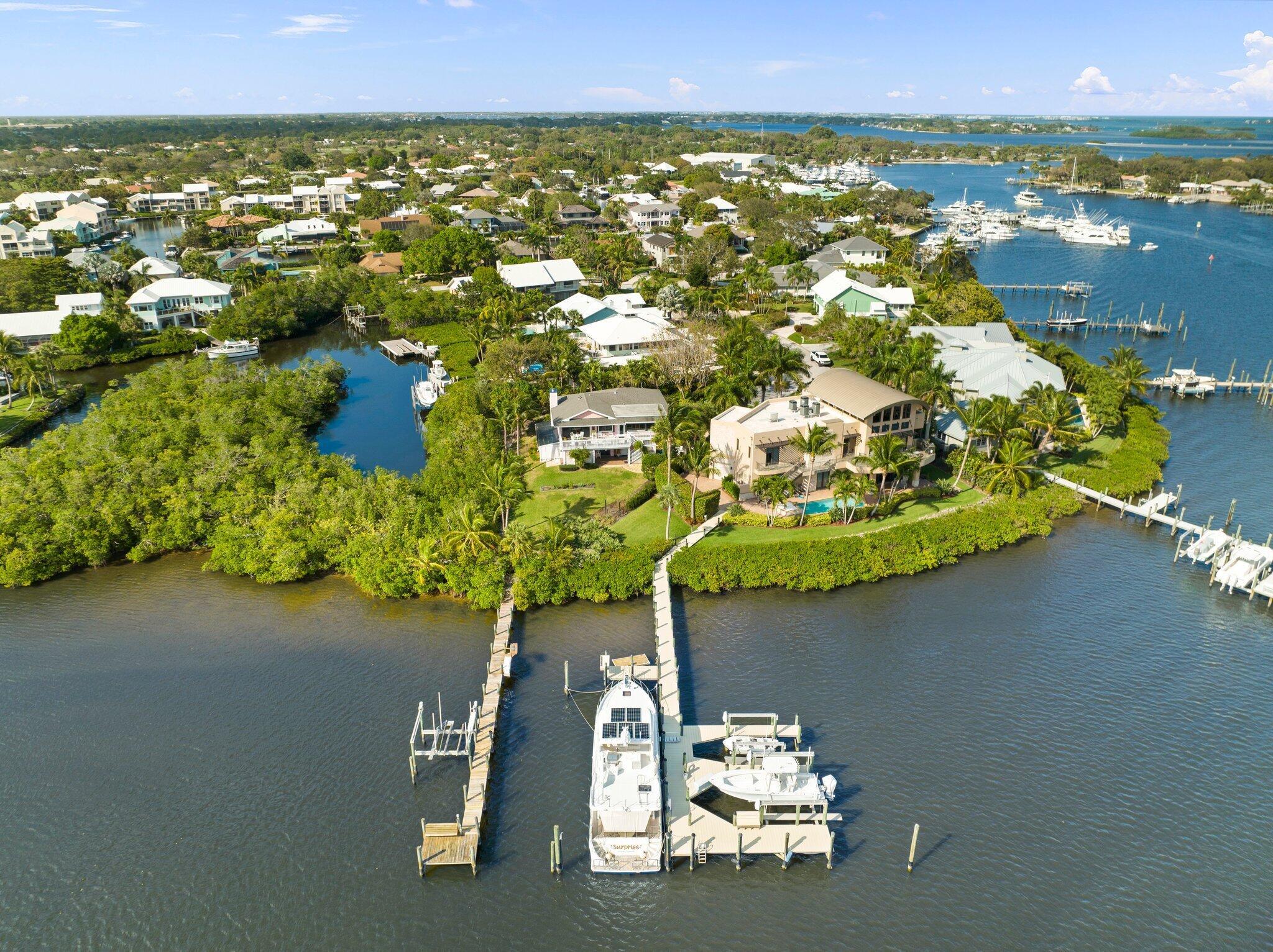 Discover this boaters dream home located in the exclusive community of Mariner Cay! Bring your yacht-7ft draft! Just minutes by boat to the inlet, this home sits directly on the wide Manatee pocket with deep water & dock that can accommodate multiple boats + a 16klb lift! 1st floor CBS! 3 car+ golf cart garage! The 1st floor features 2 BR's, den & bath - 2nd floor is your main living area with kitchen, dining, & family room that boasts high ceilings w/ beams & expansive views of the Manatee Pocket. The Master suite had a complete remodeled bath in 2021. You will love spending time on the large deck! The property is home to over 22 palm trees & mature landscaping- a true tropical paradise! SE exposure!