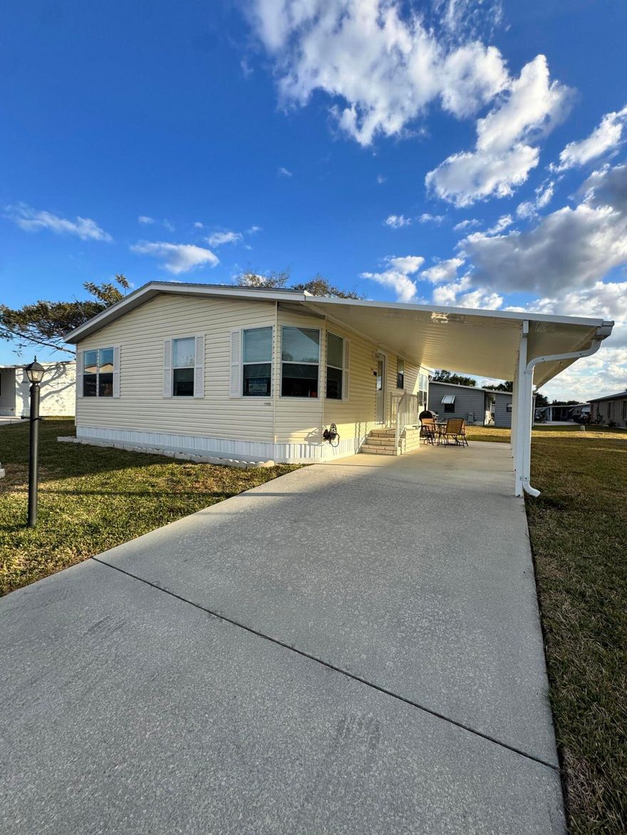 Well-maintained 2-bedroom 2-bath home in the desirable 55+ Spanish Lakes Fairways community. This home is on a street right across from the community center. Close to the entrance of the park and sits on a very quiet cul-de-sac. Home has no carpet; laminate floors throughout.  The kitchen has a desk area and a pantry for extra storage. The kitchen boasts new appliances. The washer and dryer are inside the home. The patio off the back of the home has ceramic tile and windows that close. Air conditioning in the patio. The roof is 2018, the A/C has been maintained, and the plumbing has been updated.  Home is being sold furnished. Lawn care and trash removal included in lot rent. 2 pools, tennis, pickleball, bocceball, shuffleboard. clubhouse, 18-hole golf course, and much more.