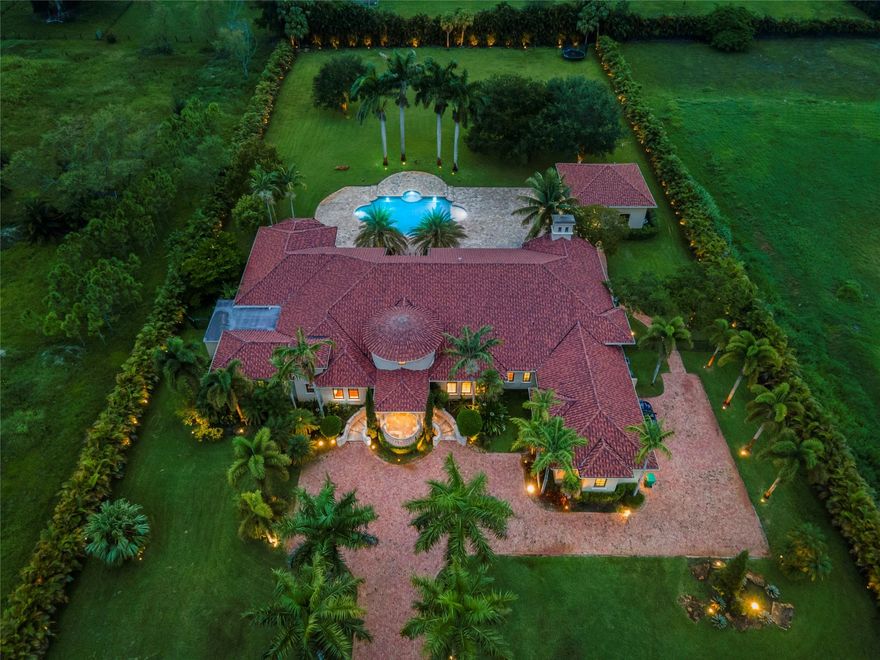 Buyer financing fell through, price reduction Indulge in the epitome of luxury as you enter the gates of this breathtaking Majestic Estate situated on over 2 acres of impeccably landscaped grounds. Boasting 6 bedrooms & 6.5 elegantly designed baths + lavish SEPARATE GUEST HOUSE complete with patio & state-of-the-art summer kitchen. Soaring ceilings, coffered designs, architectural moldings & floors with limestone, marble & rich wood. Kitchen with Bespoke cabinetry, 60" Wolf Range, Miele & Sub-Zero Appliances + adjacent butler's pantry. Movie Theatre & Gym, Outdoor entertainment w/ surround sound & covered lanai, overlook a resplendent gas heated salt water pool complete w/ sun shelf & spa. 500 Gal Undrgrnd Gas Tank, Hurricane Impact Windows & Doors, S.W. Ranches is an Equestrian Community!