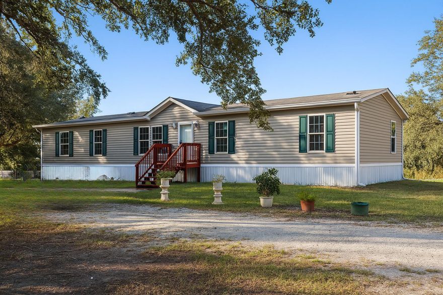 LOCATION, LOCATION, LOCATION! This 2023-built 4 bedroom, 2 bathroom home sits on 2.5 acres of cleared, fenced land with a park-like setting and beautiful oaks, all with paved road access. Inside, you'll find a spacious split floor plan with a large master suite featuring dual sinks, garden tub, and walk-in shower. The upgraded kitchen includes solid wood cabinets, butcher block countertops, and a separate dining area. Laminate flooring runs throughout, and there's a dedicated interior laundry room for added convenience. Step out back to a peaceful porch and an above-ground pool--perfect for relaxing or entertaining. The property is turnkey ready with well, septic, AC, and water filtration system already in place. Located near the Kissimmee River and Preserve State Park, this home offers