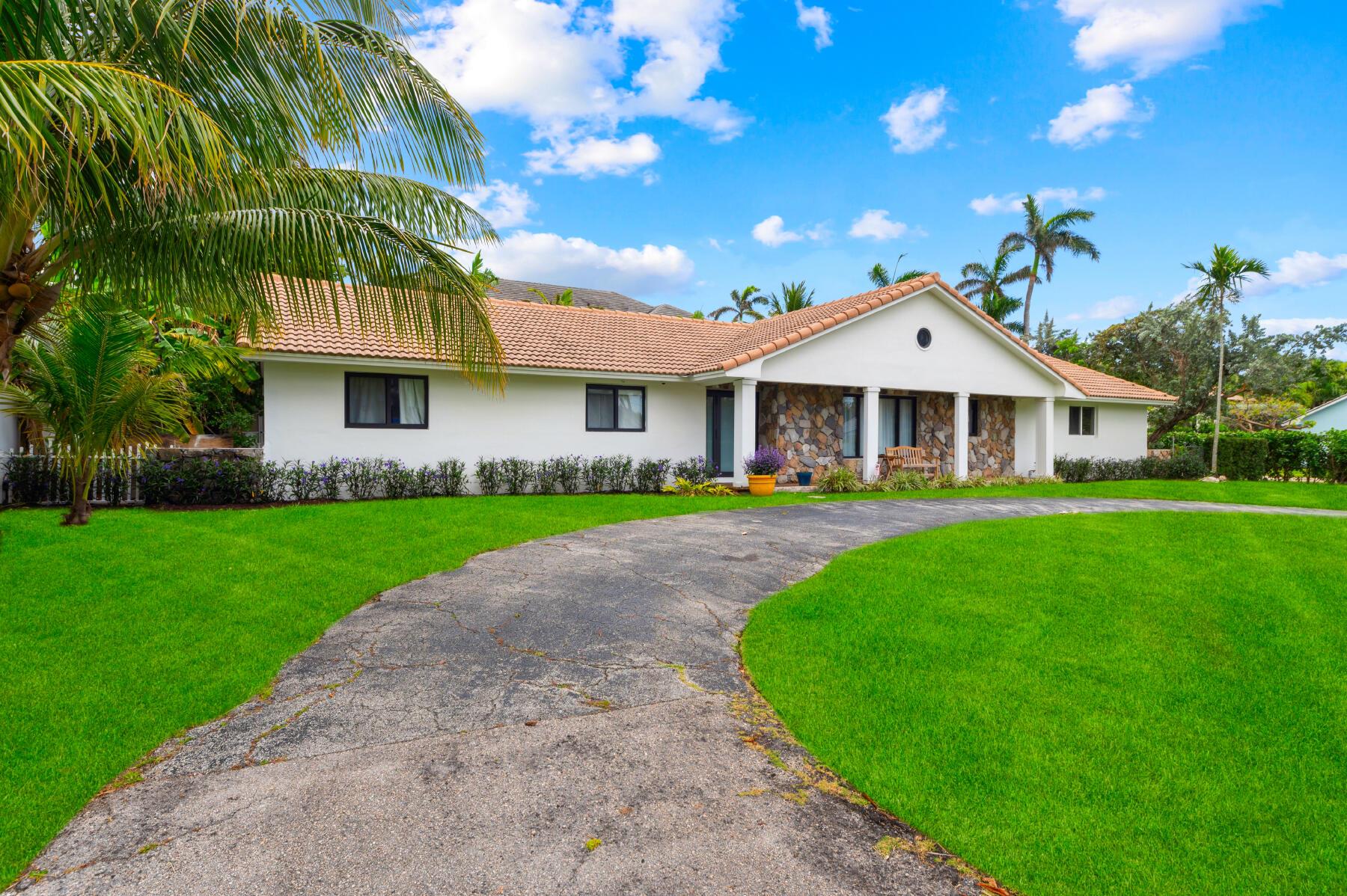 Discover the timeless allure of Florida living with this charming residence, perfectly nestled between the Intracoastal Waterway and the tranquil beach. Situated on a large corner lot, just a short walk from the sandy shores and within easy walking distance to vibrant Atlantic Avenue, this home offers an unparalleled blend of luxury, convenience, and Old Florida charm. The property features 3 bedrooms, including 2 primary suites, one of which boasts a whirlpool tub and both bedrooms have big screen TVs. The open and inviting living area is flooded with natural light through high-impact windows. It includes a baby grand piano, two guitars, and a working fireplace, making it perfect for both entertaining and relaxing. The family room is equipped for the ultimate movie night experience,