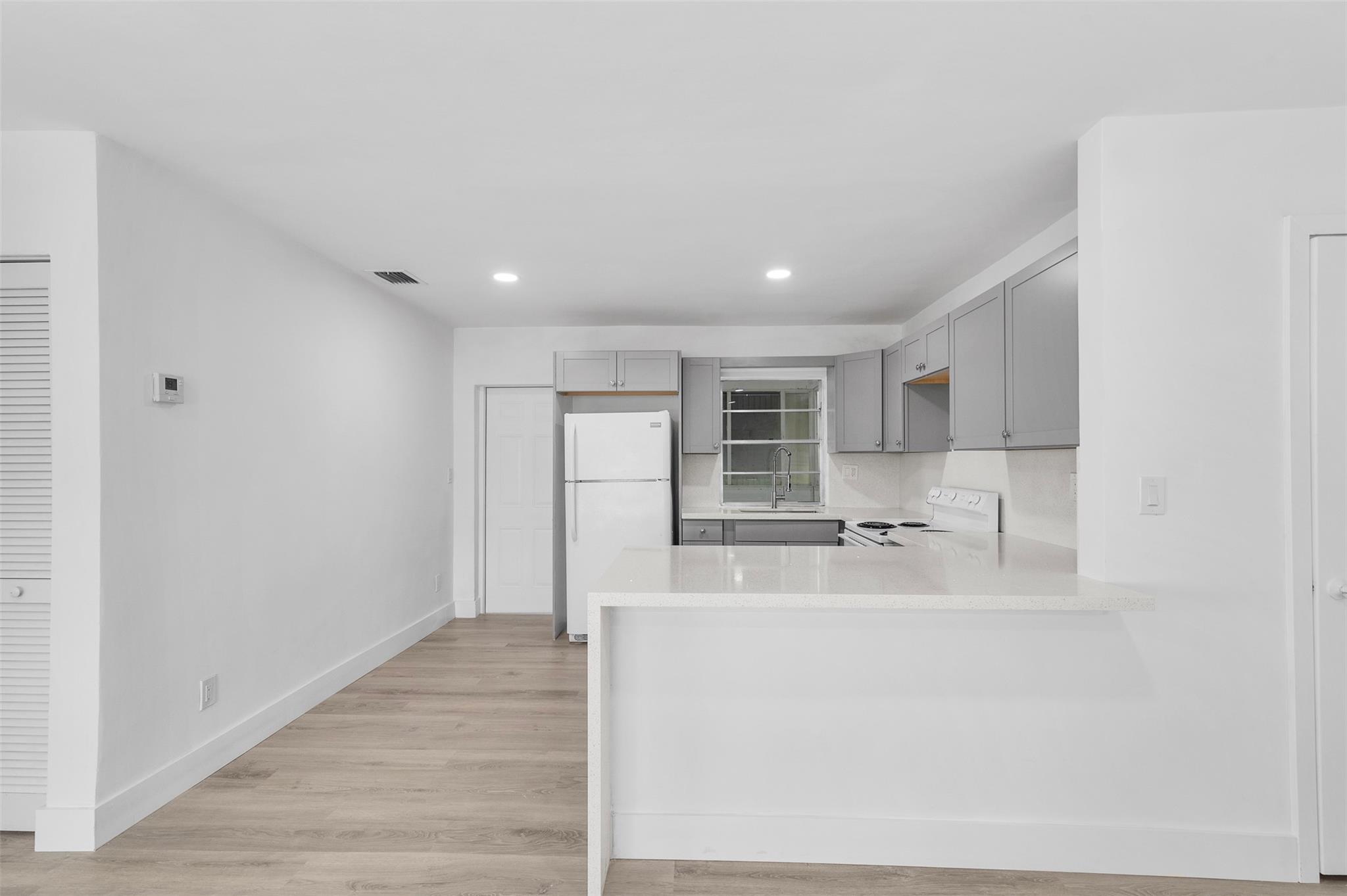 One applicant must be 55 or older. Welcome to your new home in Boynton Beach's desirable Leisureville community! This beautifully renovated residence is just two blocks from the pool and clubhouse. Enjoy a brand new AC, duct work, kitchen cabinets, speckled white quartz countertops, LVP floors, smooth ceilings, and a new bathroom with large format porcelain tiles and updated fixtures. The enclosed patio with washer/dryer adds convenience. Leisureville offers three large clubhouses with heated/cooled pools, billiards, shuffleboard, card rooms, and heated jacuzzis. The community also features an 18-hole par 3 golf course and a fitness center. Close to the beach and all amenities, this home blends comfort, style, and active living. Schedule a tour today!