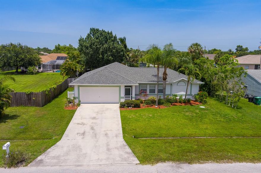Port St Lucie, but only 15 minutes to the beach?! It's true! Discover PSL's closest neighborhood to the BEACH! But why make the drive when your backyard is its own VERY PRIVATE paradise with its own Screened POOL! This Concrete Block 3 bedroom, 2 bathroom, and air conditioned and insulated 2 car garage pool home has it all! Cabana Bath to keep the freshly-refreshed guests and kids off the beautiful Real hardwood floors, Complete Privacy Fenced and landscaped backyard with only single story homes adjacent to the property for the ultimate in sun-bathing privacy, Gutters, Generator Hookup, Roof-December 2020, A/C-July 2019, water heater-2016, dishwasher-2022. Call today!