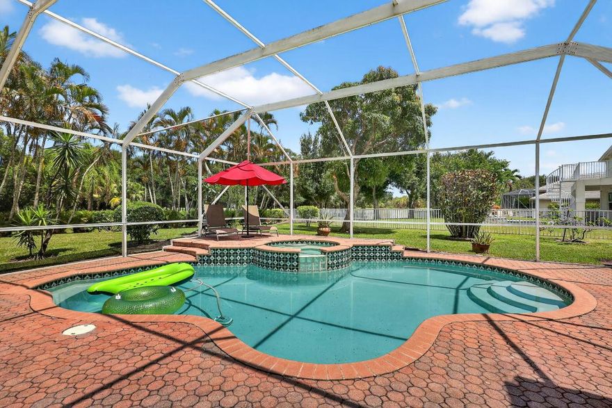 This is the ONE! New price. Elegant and spacious, this 4 bedroom, 3 full bathroom, one story pool home sits on an oversized 1/3 acre lot with a sparkling salt water pool and spa, large screened in patio that backs to the 18th fairway of Hammock Creek Golf course. It features a newer roof (2020), accordion shutters, exquisitely renovated open kitchen (2024) complete with double oven. The family room showcases a custom wall with mounted electric fireplace and TV. Luxury vinyl plank flooring throughout the main areas and bedrooms, plenty of natural light, with high end finishes. Split floorplan affords privacy, large primary bedroom and bathroom and a cabana bath. No Carpet! The Sanctuary has a private gate. Hammock Creek has no mandatory membership! Jack Nicklaus legacy design 18 hole cours