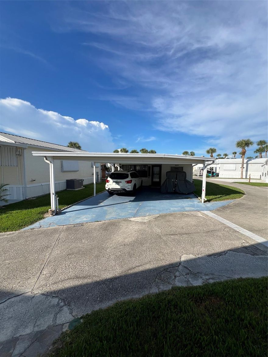 ~Ancient Oaks~ 55+ Community. Large corner lot with RV wrapped (enclosed) with huge Florida room under air. 1 bed 1 bath- furnished with a double carport. 2 outside utility rooms(workshop) washer & dryer is located in the rear one, large patio outback. This is a real cutie and ready for your winter home- priced to sell!