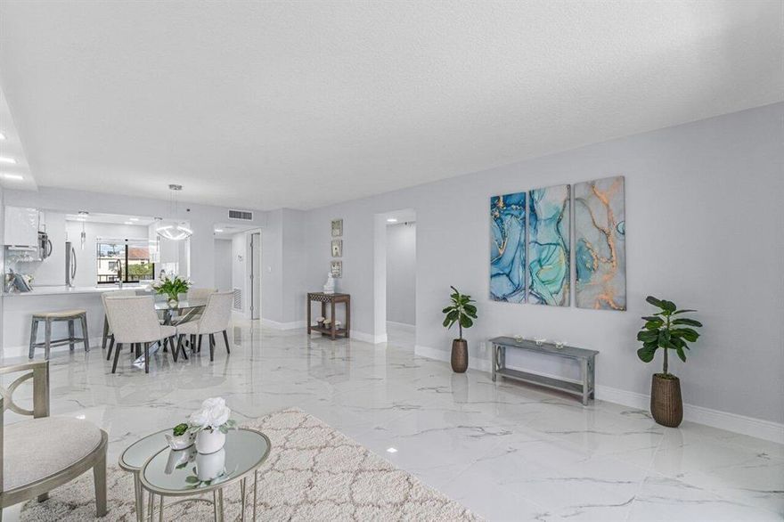 THIS LIGHT, BRIGHT & SHINY COMPLETELY REMODELED (high end finishes) CONDO IS OPEN CONCEPT w/ LONG LAKE VIEWS!  THE SPARKLING KITCHEN FEATURES HI-GLOSS WHITE CONTEMPORARY CABINETS, QUARTZ COUNTERTOPS (room for 3-4 barstools) BRAND NEW S/S APPLIANCES, SHIMMERING SUBWAY BACKSPLASH & EXTRA COFFEE STATION!  THE FLOORING IS EXPERTLY INSTALLED 30 X 30 RECTIFIED PORCELAIN THROUGHOUT!  THE PRIMARY BATHROOM HAS THE MOST GORGEOUS GRANITE COUNTERTOPS WITH OCEAN BLUE HUES, AND THE SHOWER LOOKS LIKE STRAIGHT OFF OF HGTV w/ BLUE HUES & TRANSLUCENT PENNY TILES!  THE GUEST BATHROOM HAS HI-GLOSS CABINETS, QUARTZ COUNTERTOPS & CARARRA PORCELAIN SHOWER! CUSTOM LIGHTING THROUGHOUT! A/C 2021- W/H 2019, RELAX ON THE SCREENED LANAI TO ENJOY THE LAKE VIEWS & MEANDERING WALKING TRAILS..MODEL PERFECT! WILL GO FAST!