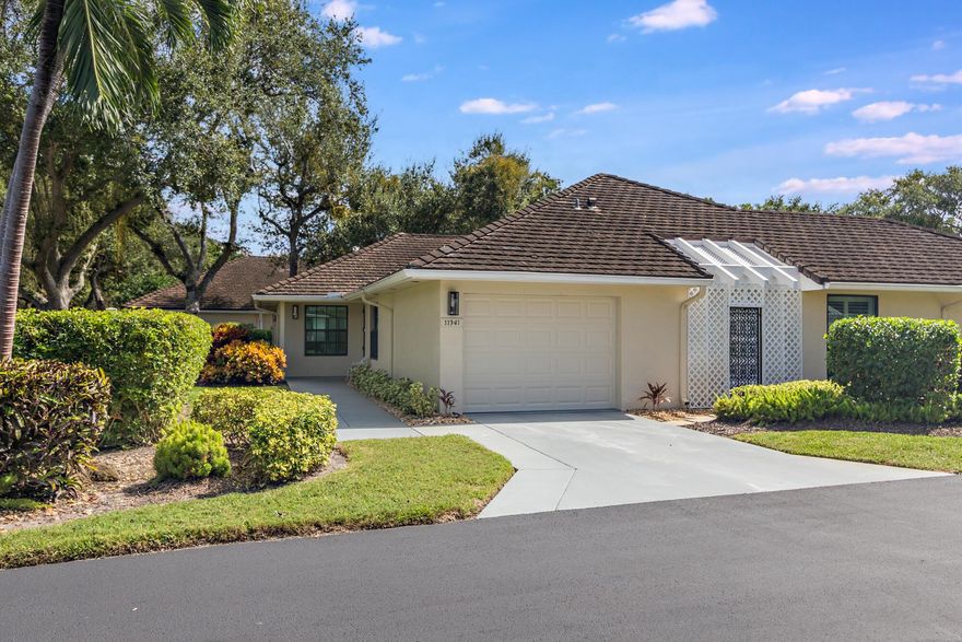 Welcome to Twelve Oaks, a premier gated waterfront community shared by majestic oak trees and offering resort-style living for the ultimate Florida lifestyle. A True boater's dream, this community features a private marina with 65 slips and no fixed bridges, providing direct access to the Intracoastal and ocean. This beautifully maintained 3 bedroom, 2 bath residence lives like a townhouse, featuring impact windows and doors throughout (including the garage) and a new AC for peace of mind. The open layout boasts vaulted ceilings in the living room and primary bedroom, creating a spacious and airy feel. A full-size washer and dryer are conveniently located inside the unit. Enjoy the tranquil surroundings and amenities - two sparkling pools, a clubhouse, and lush,