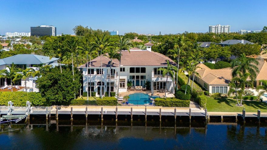 Nestled within the prestigious Bay Colony gated community, this exquisite waterfront residence exudes timeless architectural elegance and superior craftsmanship. Safeguarded by 24-hour security. Flooded with natural light, the 2-story home boasts 6 bedrooms, 7.2 baths, elevator, library/clubroom, office, a remodeled Chef's Kitchen, balconies, a 4-car garage, expandable to 8 cars with lifts. Outdoor bliss awaits with a resort-style heated pool/spa, ideal for hosting gatherings. A newly constructed 105’ dock & seawall, caters to vessels up to 85’ with direct ocean access. Featuring a brand-new roof with a 10-year warranty, this property is conveniently located minutes away from Pine Crest School, Coral Ridge Country Club, Executive Airport, the picturesque Lauderdale-by-the-Sea and Las Olas.