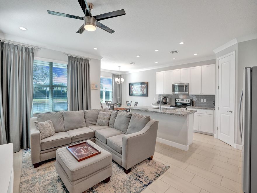 Serenity awaits at this spectacular Move-In Ready corner unit in Andalucia with spectacular lake views and modern contemporary design!  This Pristine 3BR/2.5BA +large loft boasts many custom upgrades including: High end tile downstairs as well as high quality laminate upstairs and on the custom staircase. Chef's kitchen with center island and stainless steel appliances.  All bathrooms, laundry room, and boot room tastefully upgraded with granite countertops and custom cabinets. Elegant crown and baseboards throughout the home, Ultra-Modern Wainscoting and custom floating media console in family room, custom curtains (will convey), impact windows, generator hook up, covered terrace, large fenced in back yard.  Andalucia has amazing resort style amenities and is central to everything!