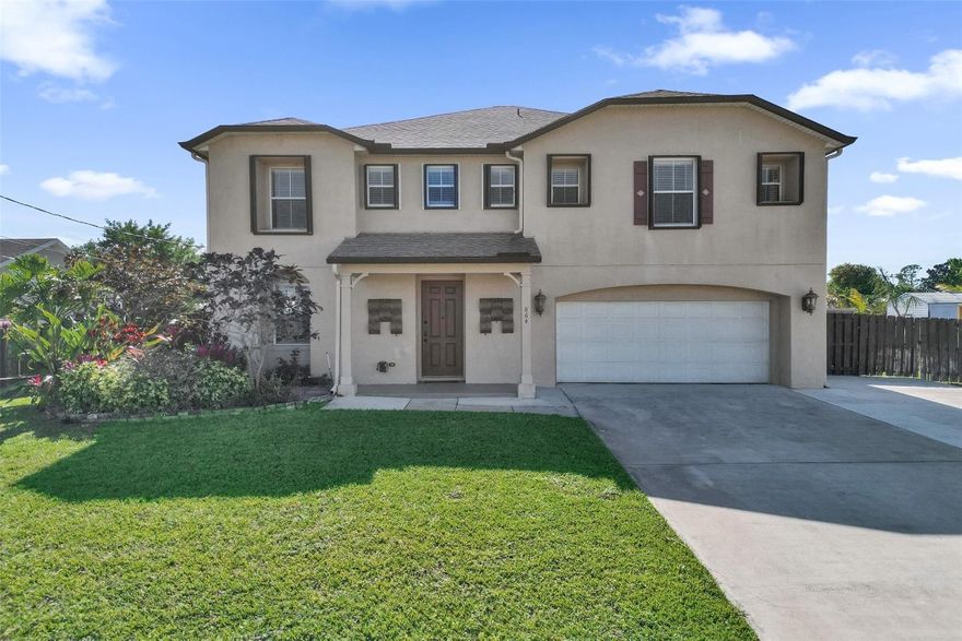 Welcome home to this spacious 3,057 sq ft two-story single-family residence designed for comfortable family living and entertainment. Featuring 4 bedrooms and 3 full baths, the thoughtful layout offers three oversized bedrooms with walk-in closets and a loft upstairs, plus a guest or in-law bedroom on the main level. Plenty of space for toys with an extra-large extended driveway for RV, boat, or golf cart parking, an XL two-car garage with storage, separate shed, and freshly finished garage floor. Peace of mind comes with a new roof (2023), fully paid solar panels, hurricane protection, wired camera system, and generator hookup. The kitchen opens to a large 10x40 screened patio, fenced yard overlooking the canal, and well-water sprinkler system—perfect for all your family entertaining.