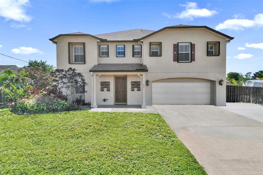 SELLER MOTIVATED!! Spacious 3,057 sq ft two-story home designed for comfortable family living and entertaining. MAJOR UPGRADES INCLUDE A NEW ROOF (2023), FULLY PAID SOLAR PANELS, HURRICANE PROTECTION, WIRED CAMERA SYSTEM, AND GENERATOR HOOKUP—providing efficiency, security, and peace of mind. This 4-bedroom, 3-bath layout features oversized bedrooms with walk-in closets, a versatile upstairs loft, and a main-level guest or in-law suite. The open kitchen flows to a 10x40 screened patio, overlooking a fenced yard and canal, perfect for relaxing or hosting gatherings, plus a well-water sprinkler system. Bring all your toys with an extra-large extended driveway for RV, boat, or golf cart parking, along with a two-car garage with storage, separate shed, and freshly finished garage floor.