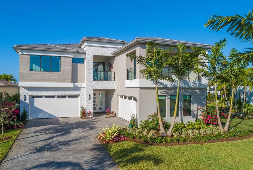 Exquisitely decorated FULLY FURNISHED Maldives MODEL HOME in Boca Raton's new contemporary community, LOTUS. Perfectly situated at the head of the lake, this Maldives Premium offers 5 bedrooms, den, clubroom, state of the art theater room, loft and a 4-car garage. This home is truly turnkey with a highly upgraded modern kitchen, double sided fireplace, built-in bar, modern light fixtures, and so much more! Modern design collides with resort style amenities inclusive of a clubhouse, restaurant, fitness center, sports complex, resort pool, tennis courts and pickleball courts. Brand new AC. The ''No Investor Addendum'' has been waived for this property.