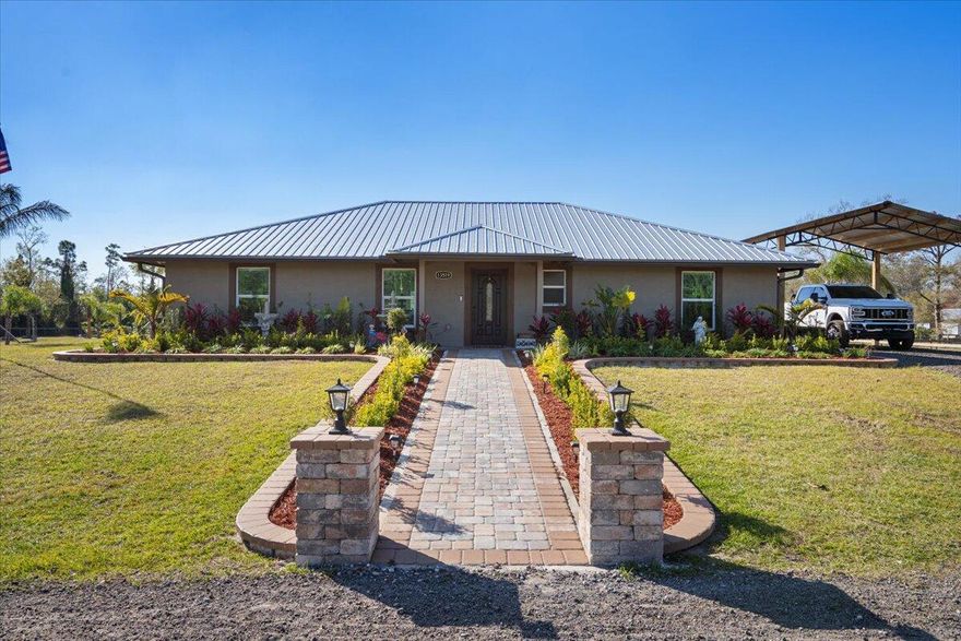 WELCOME TO COUNTRY LIVING PARADISE! Anything and everything you could want, this property has it! Welcome to this CUSTOM 2022 built Modern-Farmhouse home on 4.73 acres. Featuring 3 large bedrooms, 3 luxury bathrooms with walk-in tiled showers and glass doors. Custom doors and trim work (all burned & sealed). Chef's kitchen has granite countertops, a Forno SS 8 burner gas stove, Commercial exhaust hood, pot filler, dual-ovens, & custom wood cabinets. Wood plank tile flooring, IMPACT windows/doors, color matched gutters, tankless water heater, AND upgraded security and fire alarms. Custom TIKI HUT with DOCK on the POND, which is treated and stocked with FISH! 2024 built 40x100 & 20x30 pole barns. Fresh milling driveway, fenced & cross fenced for animals, double automatic gated entry!!