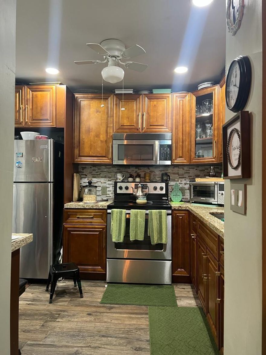 Don't let the price fool you — this one is genuinely upgraded. Renovated bathrooms with floor-to-ceiling marble-style tile, glass enclosures, and rain shower heads. Stainless steel kitchen with granite counters, rich wood cabinetry, and a pass-through that opens the space. Tile flooring throughout. Stylish barn door detail. First-floor unit — no stairs, easy in and out. Located in Park South, a quiet and well-maintained 55+ garden-style community in Lauderhill. HOA is just $385/month and covers pool, clubhouse, library, and community amenities. NO minimum credit score requirement. Can be sold furnished — truly turnkey for a buyer or investor. Rent-ready immediately. Close to major highways, shopping, and bus lines. One of the best-updated units at this price point in Broward.