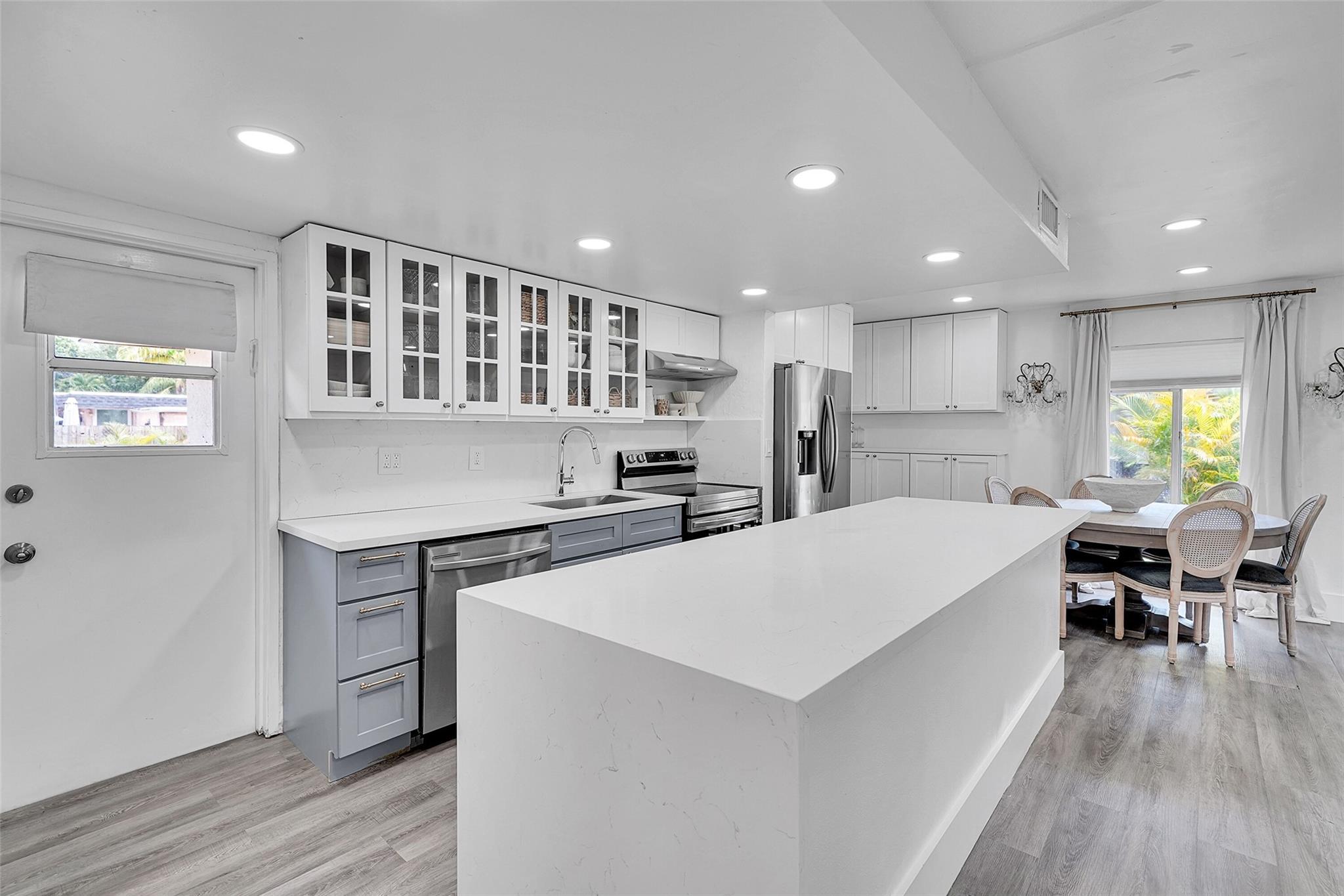 Modern charm meets family-friendly living in this beautifully updated 3BD/2BA home, featuring designer finishes and a light-filled open layout. The stunning kitchen boasts a quartz waterfall island, glass-front cabinetry, and stainless steel appliances. Enjoy upgraded bathrooms, luxury vinyl plank flooring, and thoughtful upgrades throughout. Step outside to a private, fenced backyard with mature trees, a pergola-covered patio, above-ground saltwater pool, playset, orchid trees, mango, and avocado trees. Roof 2022. Located near A-rated schools, parks, houses of worship, and the beach—this turnkey gem offers comfort, style, and convenience.
