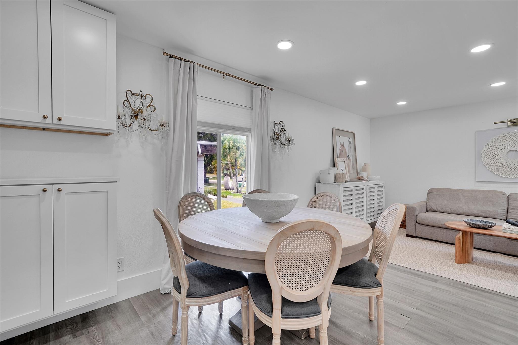 Modern charm meets family-friendly living in this beautifully updated 3BD/2BA home, featuring designer finishes and a light-filled open layout. The stunning kitchen boasts a quartz waterfall island, glass-front cabinetry, and stainless steel appliances. Enjoy upgraded bathrooms, luxury vinyl plank flooring, and thoughtful upgrades throughout. Step outside to a private, fenced backyard with mature trees, a pergola-covered patio, above-ground saltwater pool, playset, orchid trees, mango, and avocado trees. Roof 2022. Located near A-rated schools, parks, houses of worship, and the beach—this turnkey gem offers comfort, style, and convenience. Enjoy community amenities with the very low HOA of just $12/m.