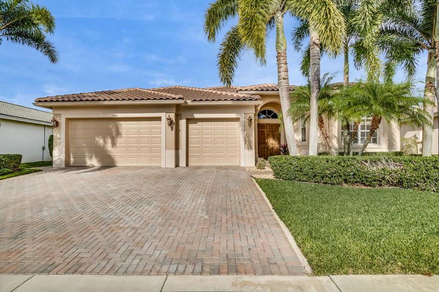 Feel the stress melt away when you walk into this well-loved, beautifully maintained home. Relax in the family room with surround sound speakers and triple-wide sliders that open to the backyard. Step outside to the summer kitchen and relax under the covered seating area. Float around the private, oversized heated pool with custom waterfall, raised spa, tiled deck, and fenced yard. Enjoy your morning coffee in the breakfast area. Entertain family and friends in the formal living and dining rooms with a wet bar and wine cooler. Admire the archways, crown molding, and oversized doors throughout. Situated in a well-managed, family-friendly community near Wellington's top-rated schools, shopping and equestrian venues.