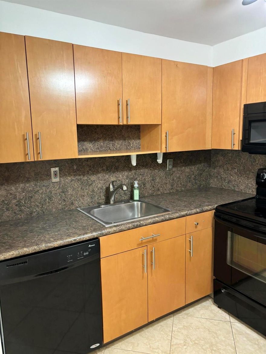 RENT IMMEDIATELY - PERFECT OPPORTUNITY FOR INVESTORS! One of the few remaining ''rent right away bldgs''! Nicely remodeled, much sought after, first floor unit in fully funded bldg.  Lovely tenant in place for the next year.  $1550/mo.The condo boasts a remodeled kitchen with a new stove and newer appliances.  The condo has tile throughout and new LVP in the bedroom and guest bath.  The remodeled primary bathroom has a walk in shower.  The screened in patio houses a newer full size washer and dryer with extra storage.  Patio has roll down storm shutters.  There are newer blinds and verticals throughout.  New led lighting in both bathrooms. Parking spot is conveniently located a few steps from the unit.