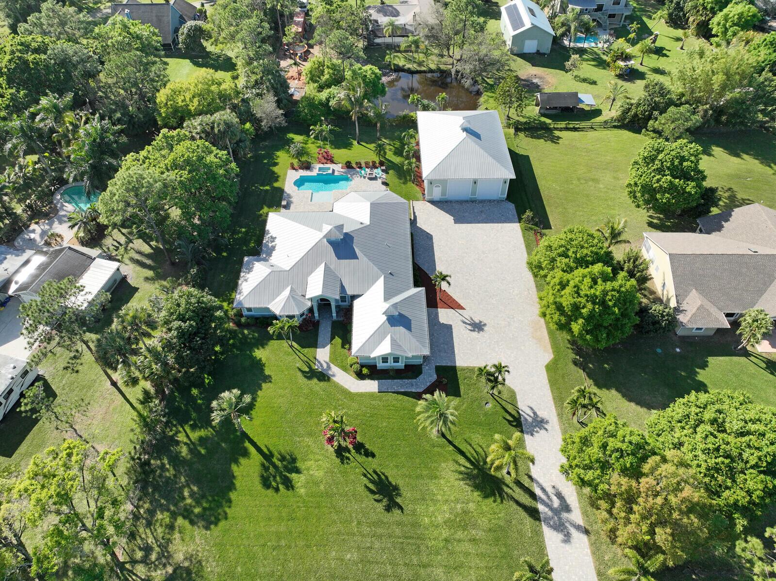 This Home is like no other in the area with the quality & workmanship incomparable to other homes in this price range, appreciated by the most particular & selective. For full details, scroll through photos to see the List of Upgrades. Main Home is a 5,043 sq ft 4 bedroom 3 bathroom 2 1/2 Car Garage 2015 CBS construction w/Metal Roof, Impact Windows & Doors, SAFE ROOM with rebar, solid concrete poured columns, solid concrete ceiling & VAULT door. Saltwater Pool, PLUS a 2015 Detached CBS 62'x43' air conditioned 17' tall Building/Shop with Guest Apartment & Full Bathroom plus enough room to park 6 more vehicles! Shop has impact windows, interior stucco, custom compressed air system. The High end luxury features are just the beginning of what this property has to offer.