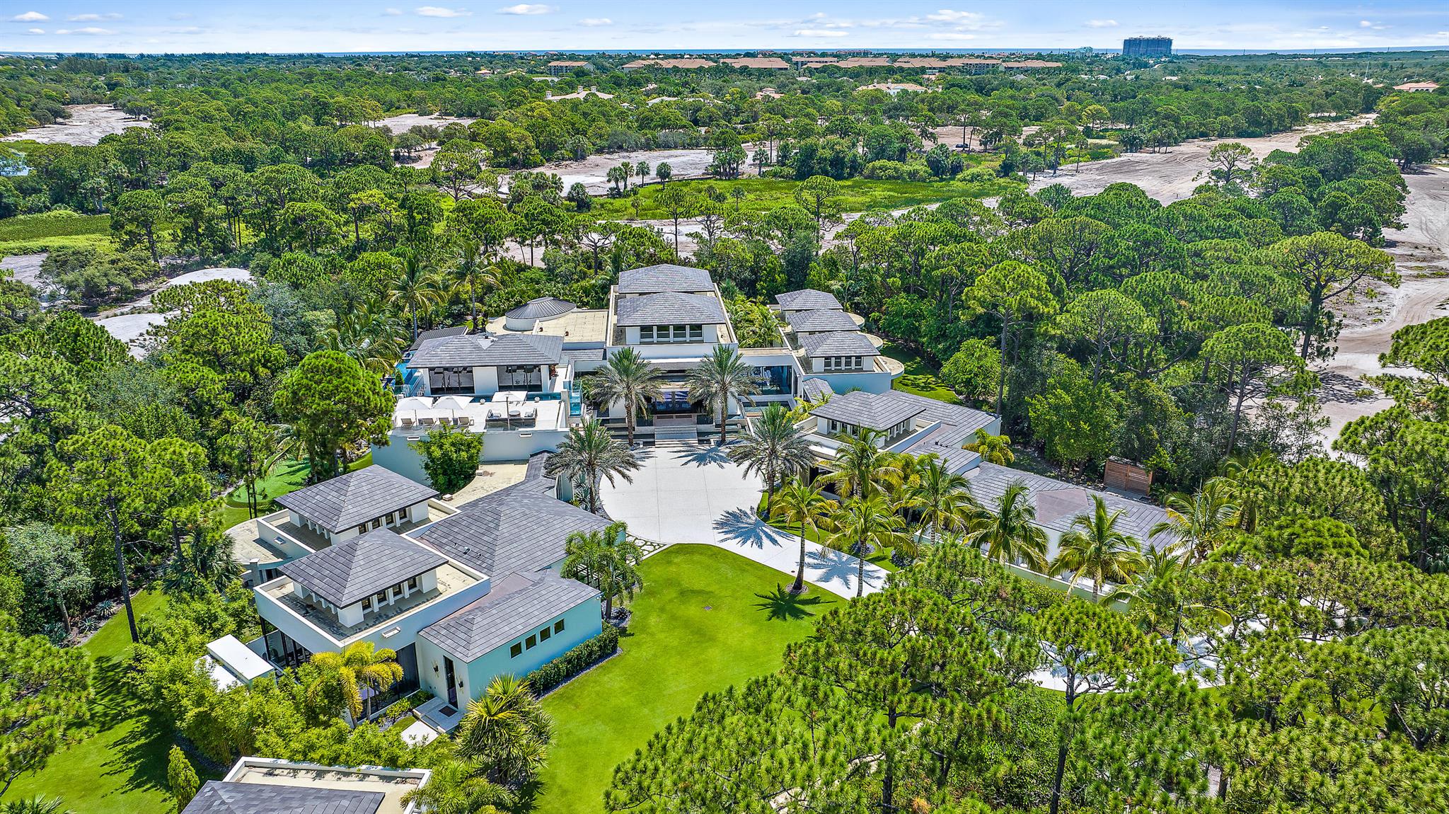 This 25,500+SF resort-style estate is privately positioned on a sprawling 2.4 acres in one of Jupiter's most sought-after communities: The Bears Club. Designed for luxurious well-being, this architectural masterpiece offers unmatched amenities in a single-family residence. Immerse yourself in the fully equipped fitness center, salon, spa, or massage room; stay on top of your game with the golf simulator; or get some reps in the 2nd level lap pool. Wind down in the meandering oasis pool with swim-up bars & cascading waterfall, regale in the game room or in one of the thoughtfully curated lounge areas. This home truly embodies the perfect blend of stunning architecture, spacious living, endless entertainment, and a rare lifestyle.