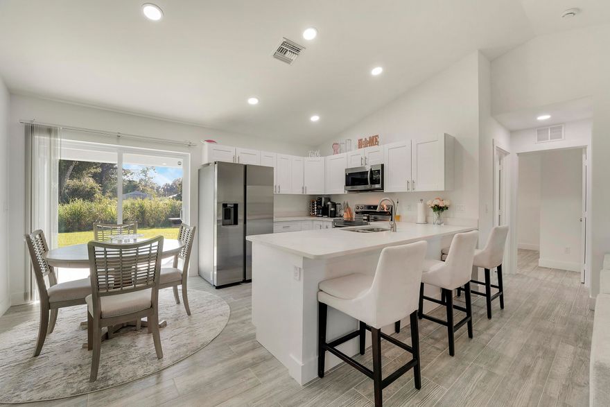 Beautiful BRAND NEW 3 bdr, 2 bath home located in a quiet Okeechobee neighborhood with NO HOA. Open concept floorplan with a modern kitchen featuring granite countertops & ample cabinetry. The primary suite offers a spacious layout with walk-in closet & bath with dual sinks & large shower. IMPACT WINDOWS, DOORS & SLIDERS throughout for energy efficiency & storm protection. CERAMIC TILE FLOORING THROUGHOUT, NO CARPETING! Enjoy Florida living on the covered front & rear porches. Situated on a NEARLY ¼-ACRE LOT with wide concrete driveway. MOVE-IN READY 2024 NEW CONSTRUCTION with powerful water softener system.