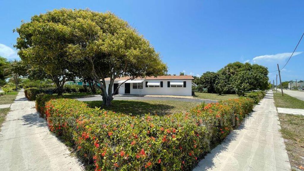 Photo of 805 Date Palm Drive, Lake Park, FL 33403 (MLS # R10930131)