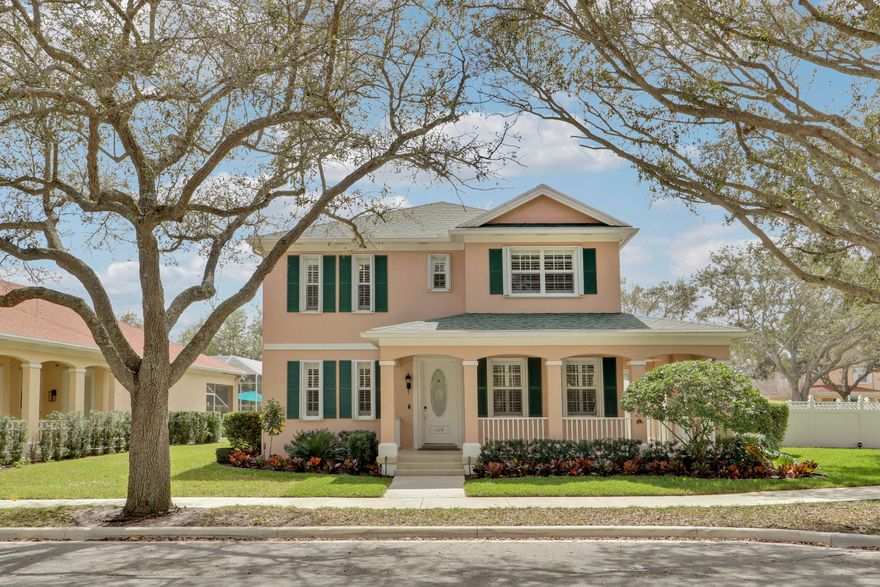 Nestled along the oak lined canopied streets of Cambridge in Abacoa in the heart of Jupiter lies this impeccably maintained CBS (concrete) 4 bedroom, 3 bath plus den pool home situated on a corner lot built by Divosta in 2001. This home includes a newer roof (2023), complete accordion shutters and a stylish wrap around front porch perfect for socializing with neighbors. A resort-like private fenced backyard boasts a custom heated salt water swimming pool and spa with a travertine paver patio, a synthetic turf lawn, elegant landscaping and a hurricane rated awning to shade the southern exposure. Inside, you will enjoy an open fully updated eat in kitchen complete with quartz countertops, Bosch 800 series stainless steel appliances (2024 & 2025), beautifully updated kitchen  cabinets all overlooking a spacious family room perfect for family movie nights and entertaining guests and family for the big games. The primary level also includes a spacious formal dining room and private office with a murphy bed making it ideal for work and housing guests alike. In addition a second smaller ground level office space with a door perfect if both adults work from home. The second level includes the primary suite with his and hers closets as well as the washer and dryer. The primary en suite is beautifully updated and includes his and her sinks, a separate shower and a soaking tub. There are 3 secondary bedrooms as well on the second level all wonderfully updated and ready for the family. The secondary bathroom includes dual sinks and a combo tub/shower as well. The owners of this masterpiece spared no expense and additional features and upgrades include a freshly painted interior, luxury plank flooring, plantation shutters, crown molding, a newer central AC system with UV (2020), a newer washer and dryer (2023), a new pool heater (2025) and pool pump (2025), 5 1/4" thick baseboards, updated light fixtures and ceiling fans, smart home light switches, tamper resistant outlets for child safety, updated interior doors and door hardware, cabinet hardware, a new garage door, a child safety pool fence and much more. Everything down to the mechanisms of the windows have been replaced. A 2 car garage plus an additional 2 car open paver pad provide plenty of parking. The home is situated across from a lovely deep wooded preserve and hiking trails. Residents of Cambridge at Abacoa have the use of a community clubhouse available for rent along with a large community swimming pool and playground area for children. The natural preserves within Cambridge offer beautiful surroundings with walking trails to enjoy the natural Florida landscape and wildlife. Do not miss this stunner!