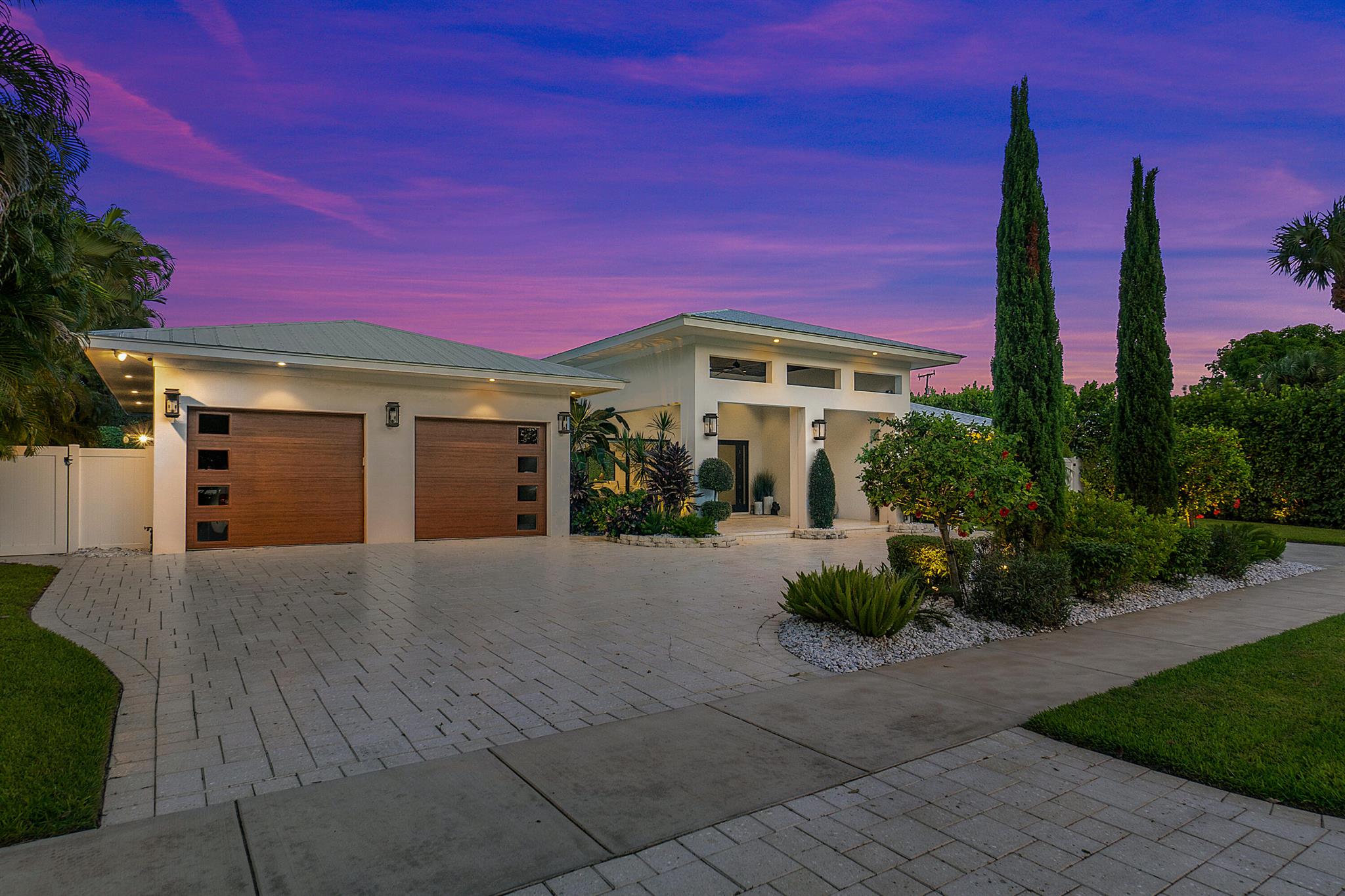 Rent in the heart of Delray's top spots. Sprawling newer single-story home in desirable Lake Ida Neighborhood. Impeccably renovated with utmost attention to every detail. Across the street with views of Lake Ida from the covered front porch and outdoor living area with projector tv, this stunning home is a gorgeous retreat to relax and unwind. A wide drive and a 2-car garage provide ample parking for family and guests upon arrival. Multiple outdoor living areas and patios create pockets of space for enjoyment and privacy. Lounge by the saltwater pool with spa and sun shelf or entertain at the covered summer kitchen with built in grill. The backyard is fully fenced and lushly landscaped creating a tropical oasis that evokes beauty and serenity for you and your guests.