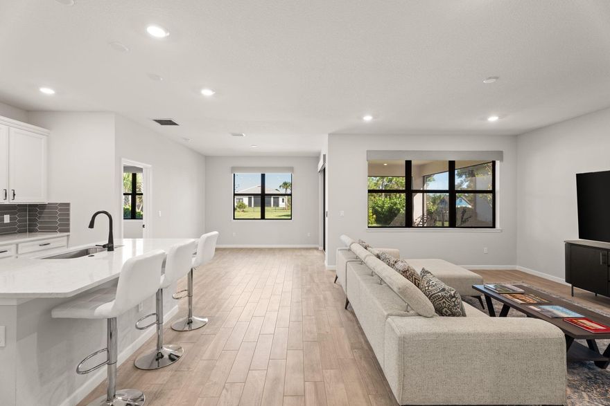 Better than new! Built in 2024, this 3BR/2BA home in Veranda Gardens offers exceptional value with NO Veranda 1 CDD--over $1,884/year savings and $50K+ over the life of a loan! Enjoy an extended screened lanai with peaceful preserve and pond views, upgraded wood-look tile floors throughout, roll-down blinds, and open-concept living. The chef's kitchen features white cabinets, Quartz counters, gas range, island, SS appliances and walk-in pantry. Spacious primary suite with tiled walk-in shower and large closet. Extended driveway fits 4 cars. Resort-style gated community with clubhouse, pool, fitness, courts, dog park & more.