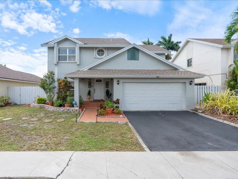 Beautifully maintained and move-in ready, this 4BR/2.5BA lakefront pool home is tucked in a quiet Pembroke Pines enclave. Enjoy a freshly painted exterior, ceramic tile floors, sunken living room with recessed lighting, and a decorative fireplace. The renovated kitchen features 42" wood cabinets, granite countertops, and stainless steel appliances. Dining, den, and kitchen overlook a resurfaced pool and peaceful lake views. Upstairs includes all bedrooms, new carpet, wood staircase, and a spacious primary suite with Roman tub, shower, and walk-in closet. Outdoors: mango and coconut trees, covered lanai, and private lakeside bench. Recent upgrades: HVAC (2022), water heater (2024), plumbing (2024), and updated baths. Close to I-75, top schools, shopping, and dining.