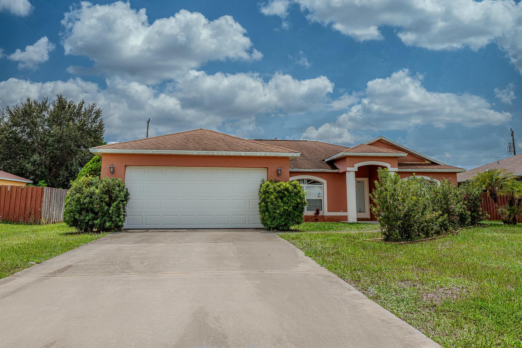 This solid CBS Home with high ceilings is ready for you to make it your own. Featuring a spacious screened-in patio and a backyard with plenty of room to design your dream backyard oasis. This property has endless potential. Enjoy peace of mind with full hurricane shutters. Perfectly located near I-95 and the Turnpike, as well as shopping, dining and everyday conveniences, you'll love the easy access to everything Port St. Lucie has to offer.