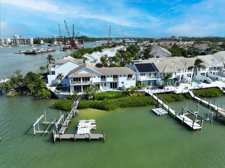 Welcome to the pinnacle of coastal living at Jupiter Harbour, where this 3,500+ square foot townhome redefines luxury and convenience. Elevate your lifestyle with a private elevator, ensuring seamless access to every level of this meticulously designed residence. The panoramic views of the Intercoastal waterway through hurricane impact windows add an element of awe to your daily living.

Imagine waking up to the serene beauty of the Intercoastal, just a short 5-minute walk from the pristine sands of the ocean. This residence not only embraces the natural beauty of its surroundings but also provides a secure haven with hurricane impact windows, ensuring your peace of mind and protection against the elements.

For those with a passion for boating, a brand new 24,000-pound boat lift awaits, promising effortless access to the open waters for your vessel. The heated pool invites you to indulge in year-round relaxation and entertainment, while the newly constructed dock and fenced patio create the perfect setting for private moments by the water.

Discover the convenience of being within walking distance to Jupiter's finest restaurants and shopping centers, allowing you to immerse yourself in the vibrant local culture. The 24-hour gated community ensures security and peace of mind, allowing you to enjoy the exclusive amenities and the natural beauty that surrounds you.

As a resident of Jupiter Harbour, you not only have access to your private oasis but also to the community pool and tennis courts, fostering a sense of community and leisure. Positioned on the point lot of Jupiter Harbour, this townhome offers unparalleled exclusivity and privacy.

In summary, this townhome at Jupiter Harbour encapsulates the epitome of elegant, carefree coastal living. With its luxurious features, breathtaking views, and proximity to all that Jupiter has to offer, this residence presents an unparalleled opportunity to embrace a lifestyle that seamlessly blends luxury, convenience, and natural beauty. Welcome home to the waterfront haven you've always dreamed of.