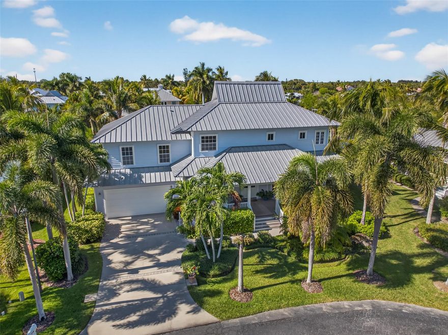 A boater’s dream in gated Riverpoint, this Key West–style home offers 100 ft of deep-water frontage, a 50 ft Trex dock, and a 12,000 lb lift with quick access to the Intracoastal and inlet. Enjoy dolphins, manatees, and birds from your backyard. Outdoor living shines with a heated LED-lit saltwater pool and front and rear porches. Inside features soaring ceilings, an open kitchen with granite and a gas cooktop, bamboo floors, loft, private primary suite, metal roof, new storm shutters, and a 2024 repipe.