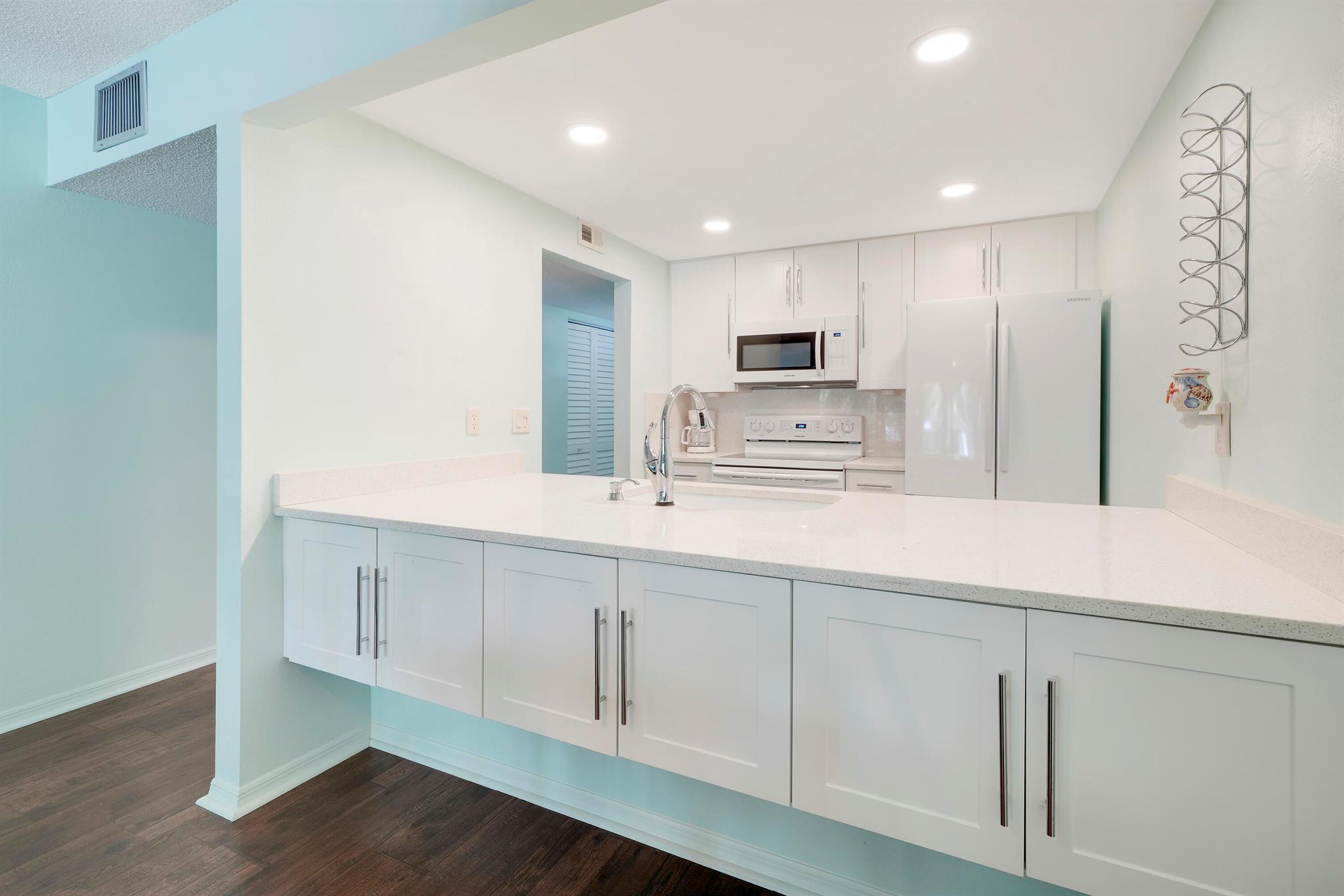 This charming 2nd floor, 2BD/2BA unit in a pet free, active 55+ community of Villamar with low association monthly fees. The updated bright kitchen featuring custom cabinets & quartz counters which opens to spacious living & dining area with custom entertainment center to match kitchen cabinets & quartz counters. Relax outside on your covered porch. Centrally located near shops and restaurants. Get to area beaches within minutes. Move-in ready