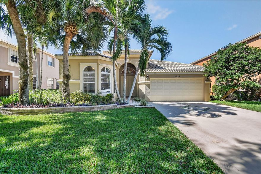 Welcome home to Madison Green! This 3-bedroom, 2-bath home is nestled in one of Royal Palm Beach's most sought-after communities. You'll love the spacious feel of the 3-way split floor plan that offers both comfort and privacy for the whole family. The kitchen is light and inviting, featuring granite countertops, stainless steel appliances, and plenty of cabinet space for all your cooking needs. Each bedroom has beautiful bamboo flooring and generous closets to keep everything organized. Step outside to your own private, screened-in patio, the perfect spot to enjoy your morning coffee or unwind after a long day. Surrounded by lush, tropical landscaping, it's a peaceful retreat designed for relaxation and privacy.Madison Green offers resort-style amenities, and a beautiful golf course.