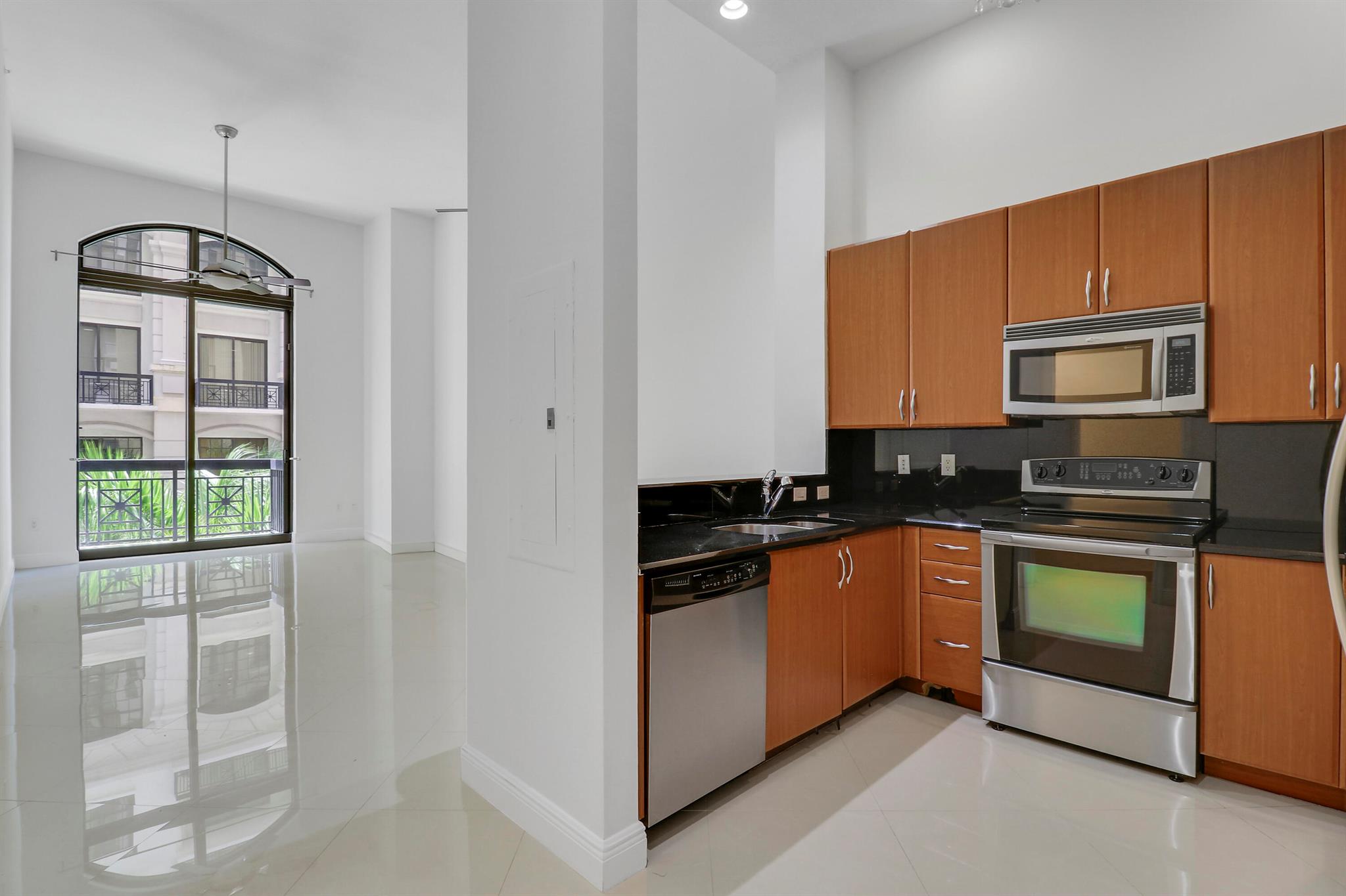 Spacious One-Bedroom, 1.5 Bath Condo with Luxe Features! Discover a truly exceptional one-bedroom residence that stands out from the average. Boasting soaring 14-foot ceilings, this residence offers an open, airy atmosphere filled with natural light. The expansive living areas are adorned with elegant large porcelain tiles, while the bedroom features brand-new, never-used plush carpeting for maximum comfort.Enjoy the outdoors from not one, but two private balconies--perfect for relaxing or entertaining. Ample closet space ensures your storage needs are well met, complementing the oversized primary bathroom finished with luxurious marble. The primary bath features a relaxing soaking tub and a separate shower, creating a spa-like retreat.