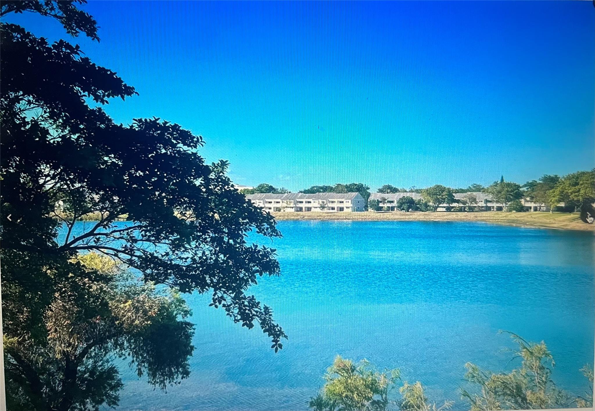 Welcome to this outstanding lakeside community offering serene water views from every room! Nestled in a charming Key West-style gated enclave, this community sits on a pristine 23-acre lake, perfectly located in desirable Oakland Park. Enjoy the convenience of being just minutes from major highways, FT. Lauderdale-Hollywood Intl. Airport, & the beautiful Lauderdale-by-the-Sea beach—home to endless entertainment, restaurants, & cafés. This large, bright condo is truly a must-see. Recently updated, it features brand-new, light wood waterproof vinyl flooring in the bedroom & walk-in closet, complemented by vaulted ceilings & stunning lake views throughout. The living area boasts tile flooring, an open-concept kitchen with S/S appliances, in-unit washer & dryer, & a modern, updated bathroom.