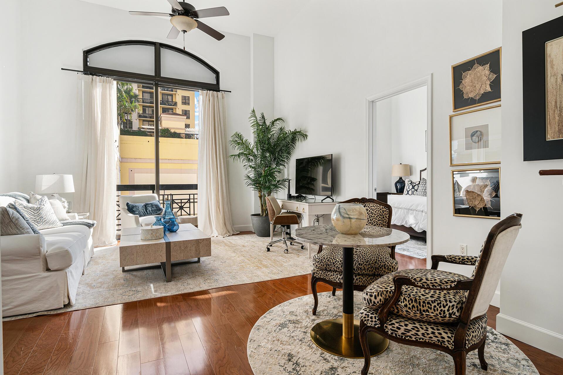 Largest 1 Bed / 1.5 Bath, single level condo, with soaring 14' ceilings. Natural light floods through huge picture windows in one of downtown's most luxury residences. New paint, wood flooring throughout, 42'' kitchen cabinets, granite counters, stainless appliances, TWO walk in closets, glass shower & separate soaking tub, double vanity, front load W/D & TWO, yes, TWO balconies. Designated garage parking & storage unit included. Building boasts complimentary valet, 24 hr front desk, resort style rooftop pool & summer kitchen, sauna, steam, lounge, indoor movie theater, outdoor movie theater, fitness center & rooftop pet walk. Walk to the Waterfront, Green Market & CityPlace. Bike to Clematis St, Norton Museum, Kravis Center & Worth Ave & the beach. Just minutes to PBIA and BrightLine.