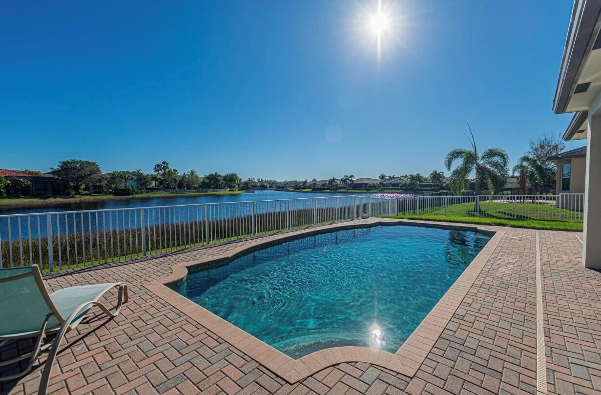 Welcome to the highly sought-after Coral Reef floor plan--renowned for its spacious layout, open-concept design, and the largest master bedroom of any model in the community. This beautifully maintained 3-bedroom, 2.5-bathroom lakefront home sits on an oversized, fenced-in lot offering expansive water views and privacy. Step inside to find a thoughtfully designed interior featuring a flexible dining area that can easily be converted into a home office, playroom, or additional sitting area. The heart of the home includes an open kitchen and living space ideal for entertaining, with windows that frame stunning lake vistas. The generously sized master suite offers ample room for a sitting area, and includes a well-appointed en-suite bath.