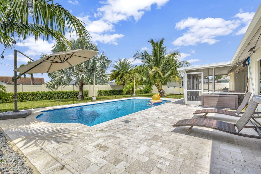 THE PERFECT OFF SEASON WELLINGTON RENTAL ! - This furnished charming 3-bedroom, 2-baths CBS pool home on 0.27 acres is a dream come true for equestrians and pet owners alike. - Modern amenities: impact windows and doors, recently renovated kitchen & bathrooms, new washer and dryer. - Large fenced backyard along the canal ideal for humans, pets, and entertaining. - No HOA restrictions mean you can move in with ease and bring your pets or dually truck. - Prime Location: Just 4 miles from top equestrian venues such as the Winter Equestrian Festival, National Polo Center, and Global Dressage. You're also minutes away from shops, restaurants, highways, and only a 20-minute drive from the beach and Palm Beach International Airport. An opportunity you won't want to miss.