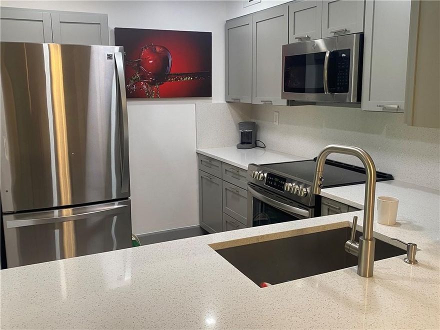 Immaculate Remodeled Unit-Brand New Kitchen with designer cabinets and Quartz Tops-Farm Sink with new Faucet and Some custom cabinetry-All new Stainless Steel Appliances-NEW AC AND HOT WATER HEATER-New Sliding closet doors, blinds, light fixtures! New Flooring in Bedrooms-Brand New Washer and Dryer-Patio is newly screened with new door and storage closet-Popcorn has been removed-Beautiful Green Views of the Complex ! Just Move in !