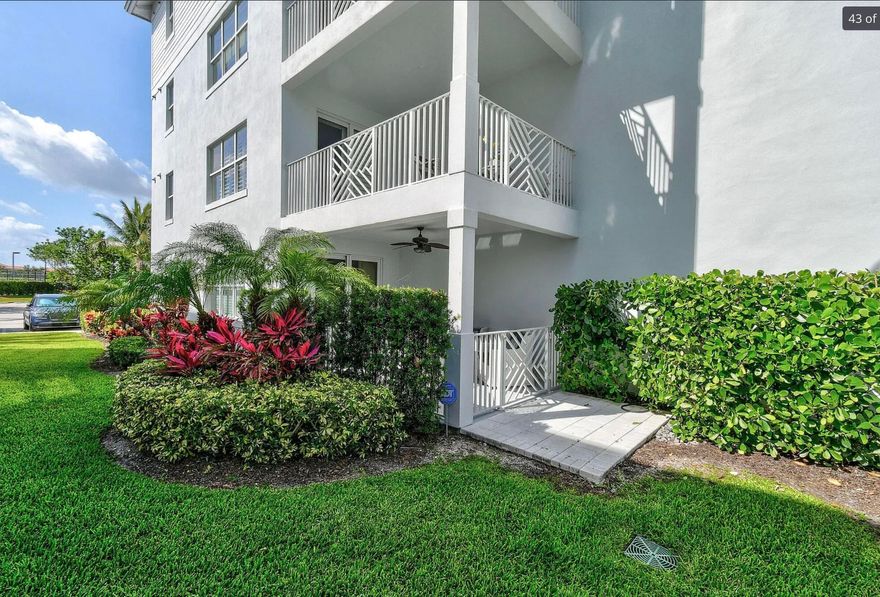 Welcome to coastal living at its finest in Bay Colony. This light-filled, first-floor residence offers 2 bedrooms, 2 bathrooms, and approximately 1,590 square feet of beautifully updated living space in the heart of Juno Beach.  Step inside to discover a bright and open floor plan featuring new flooring, plantation shutters, and modern lighting throughout. The thoughtfully designed gourmet kitchen showcases sleek quartz countertops, ample cabinetry, and quality appliances—perfect for both everyday living and entertaining. A spacious primary suite features a walk-in closet and a well-appointed bath with dual sinks and a separate shower. Enjoy the Florida lifestyle from your covered patio overlooking lush green landscaping, where you can relax and take in the refreshing ocean breezes.  Additional highlights include a utility room, extra storage, assigned parking, and impact windows. Residents of Bay Colony enjoy resort-style amenities, including a newly renovated pool and spa, tennis courts, pickleball, bocce, clubhouse, fitness center, and scenic walking paths. Boating enthusiasts will appreciate the private marina with no fixed bridges, with boat slips available for purchase accommodating vessels up to 40 feet. Ideally located just minutes from Juno Beach, world-class golf, dining, shopping, and the Palm Beach Gardens lifestyle, this home offers the perfect combination of luxury, convenience, and coastal charm.