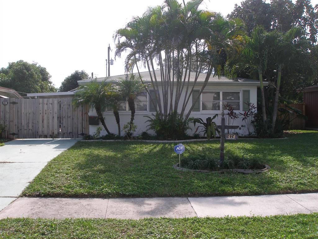 Photo of 314 Date Palm Drive, Lake Park, FL 33403 (MLS # R10788876)