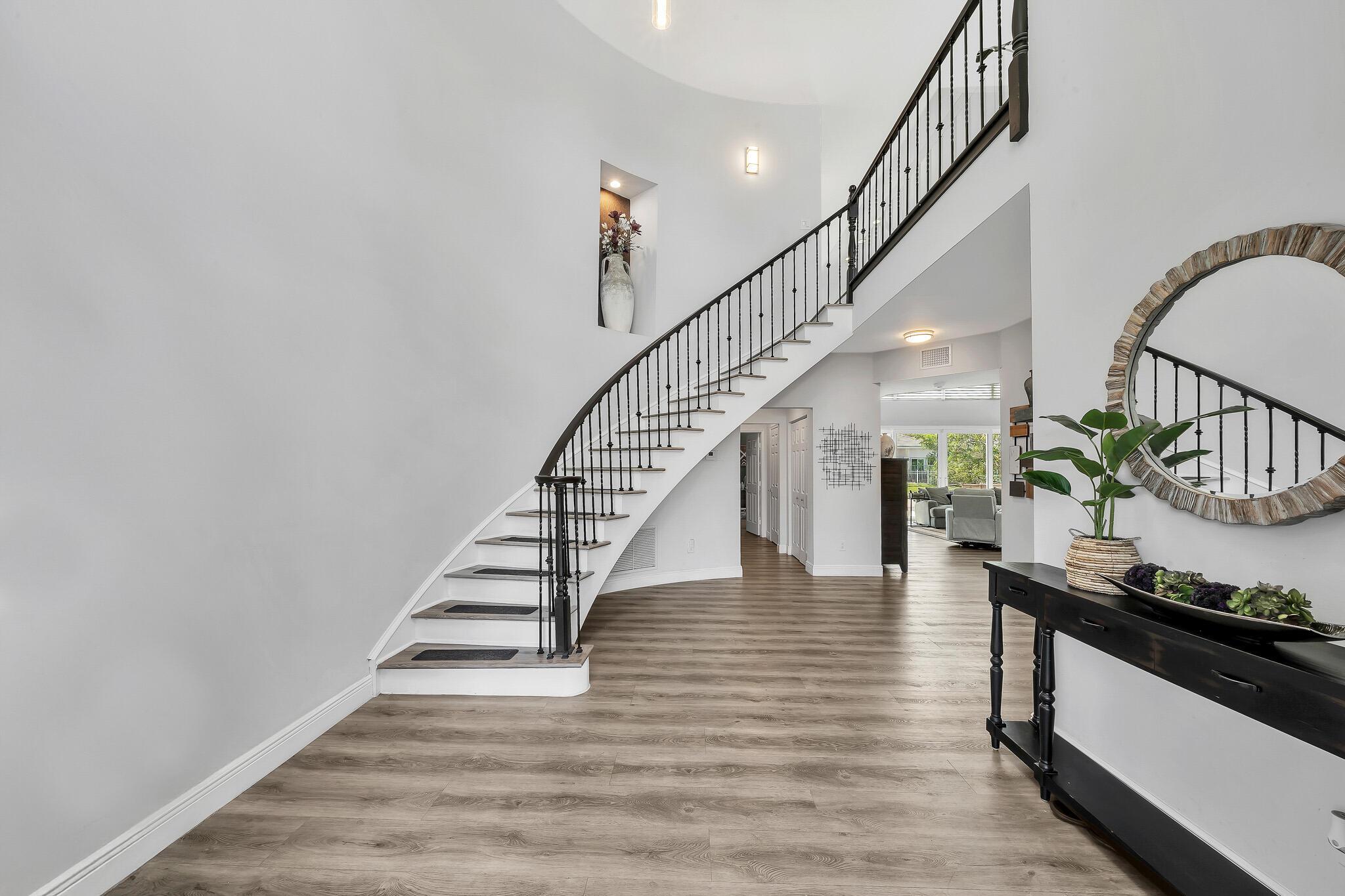 Welcome to a beautifully maintained 2-story residence located in the heart of Boca Raton's desirable Boca Pointe community. This versatile and spacious home offers a unique layout featuring dual primary suites--one on the first floor for ultimate convenience and another upstairs for added privacy--plus a generous loft perfect for a home office, media room, or guest space. This exceptionally rare corner lot, tucked away on a quiet cul-de-sac, offers a remarkable sense of privacy, creating the feeling of having no neighbors at all. Thoughtfully updated and move-in ready, the home features partial impact glass, two-zone A/C systems (2022), and a newer hot water heater (2021). The tile roof, installed in 2009, is in excellent condition, offering lasting peace of mind. Inside, you'll find a