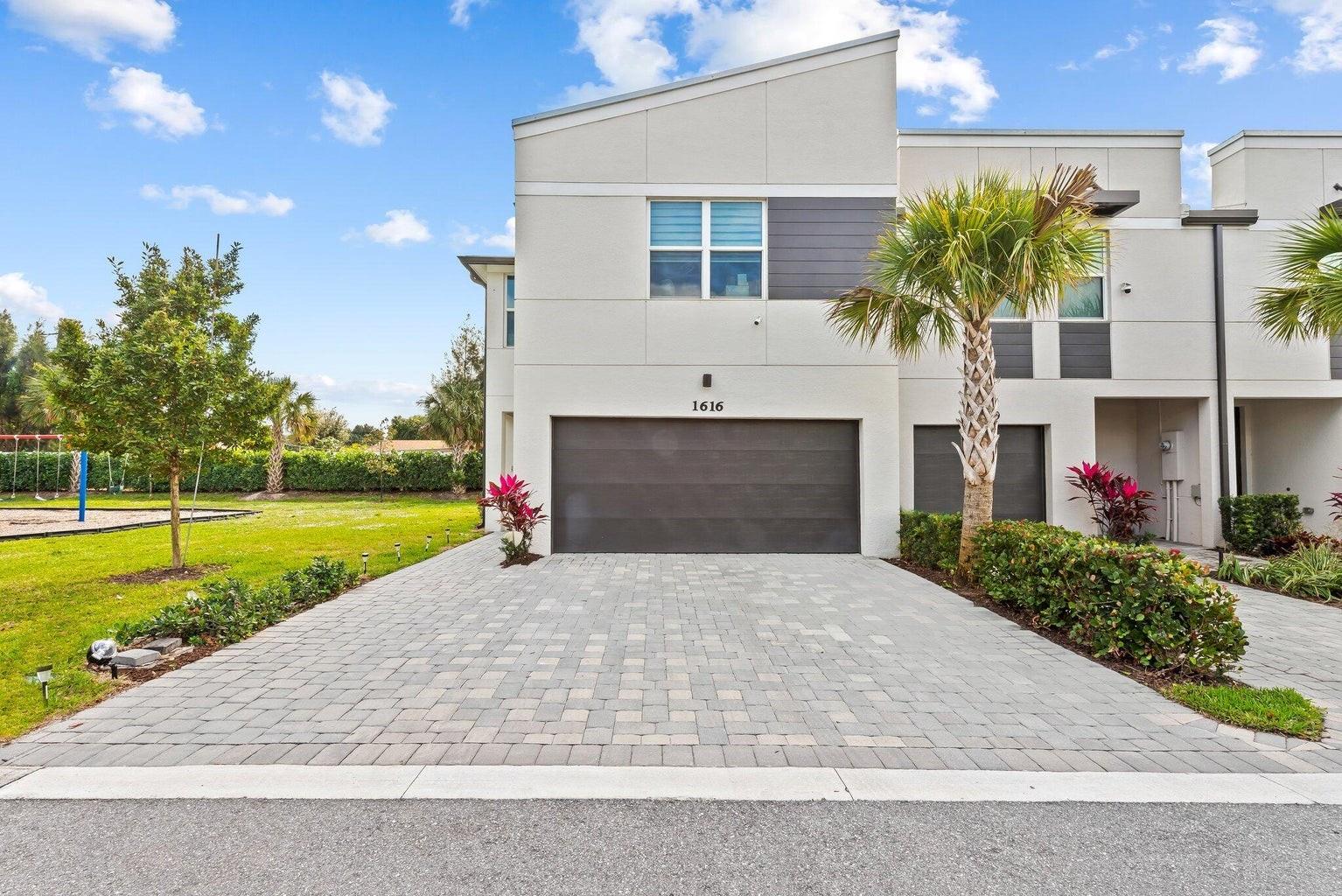 Modern 3bed/2.5bath TH combines style, comfort, & convenience in a gated community just minutes from downtown WPB. Open floor plan filled with natural light, impact windows, & chef-inspired kitchen featuring white shaker cabinets, sleek white quartz countertops, & spacious island perfect for entertaining. The first floor boasts elegant gray tile flooring, while upstairs offers neutral beige carpet for a warm, cozy feel. Upstairs, enjoy a flexible loft space, plus a large laundry room & a master suite with dual sinks & a walk-in closet. Community amenities include a resort-style pool, cabana, and playground, making it easy to relax without leaving home. Just minutes from shopping, dining, entertainment, & the beaches. Move-in ready as soon as Association approval is complete!